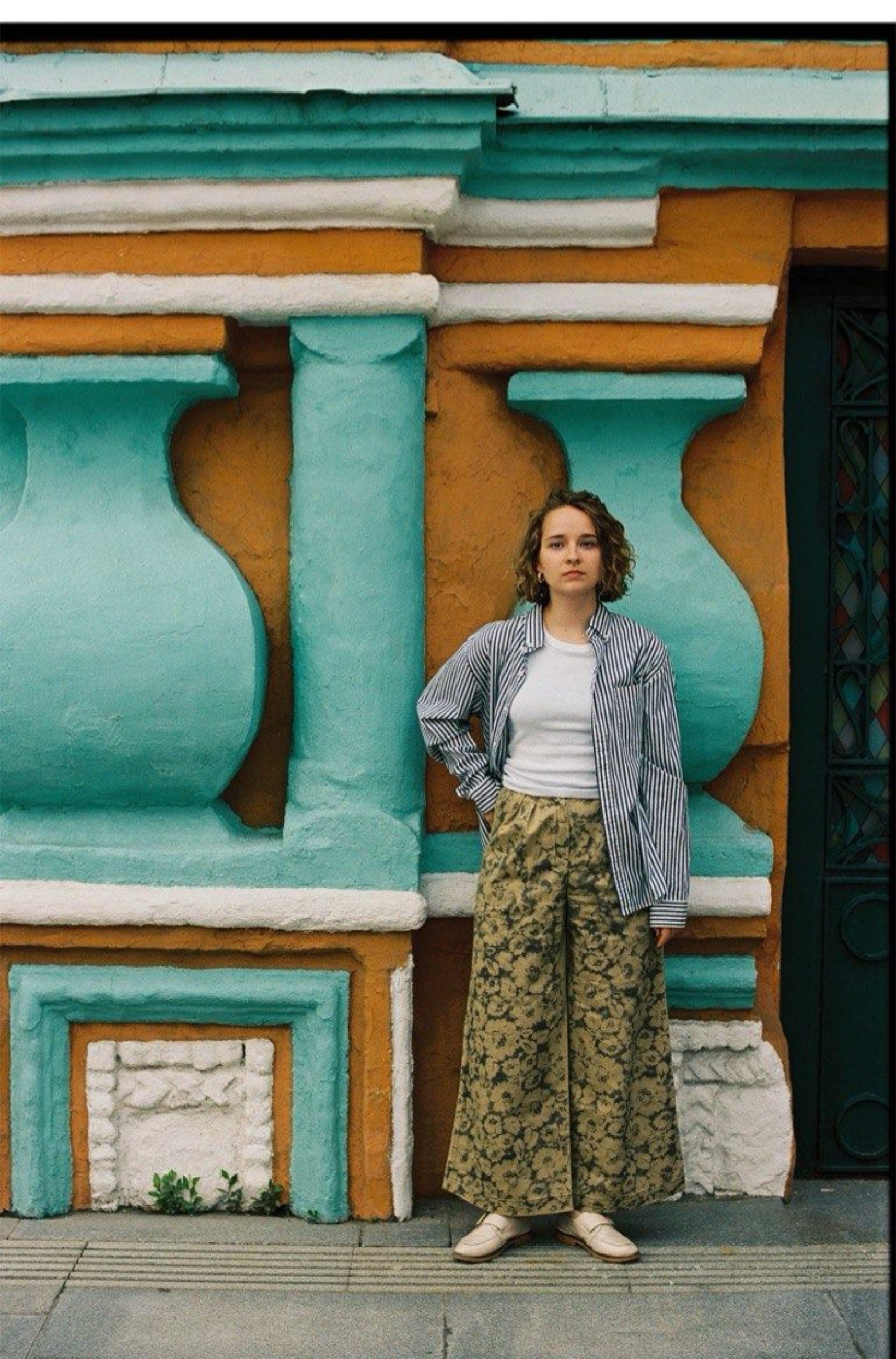 Daria Sharenkova in front of a painted facade
